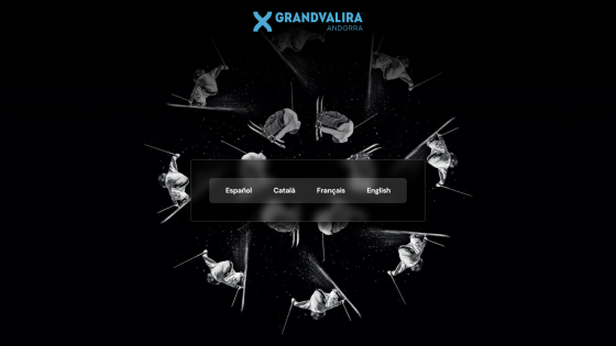 Grandvalira ski resort homepage with language options and skier images on black background