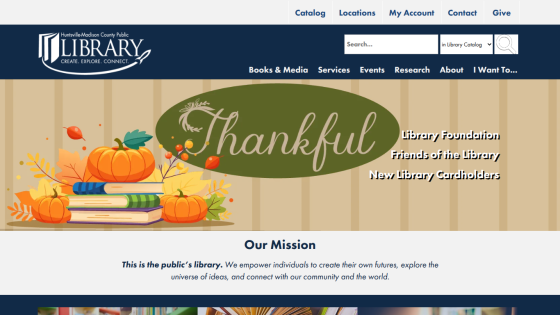 Huntsville-Madison County Public Library homepage with navigation links, search bar, thankful autumn-themed hero image, and mission statement