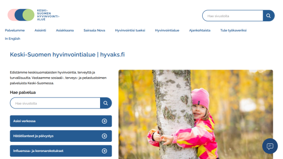 Keski-Suomen hyvinvointialue website with navigation, search bar, service links, and a child hugging a tree in autumn