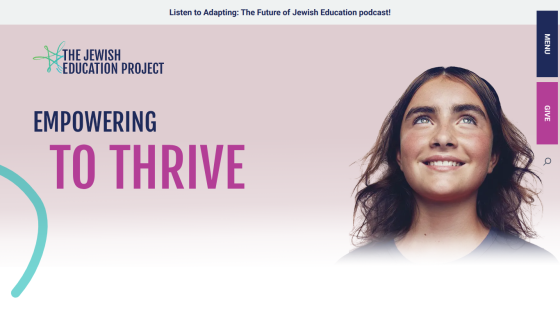 Homepage with navigation bar, large hero image featuring a person using a laptop, and headline 'Empower Your Business with Our Solutions'