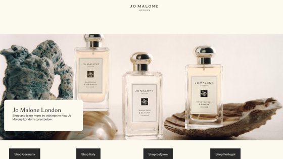 Jo Malone London homepage featuring three cologne bottles and options to shop by country: Germany, Italy, Belgium, Portugal