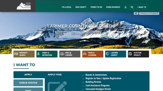 Larimer County Colorado website with mountain hero image, search bar, navigation menu, and quick links for property, parks, jobs, vehicle licensing, sheriff, and election results
