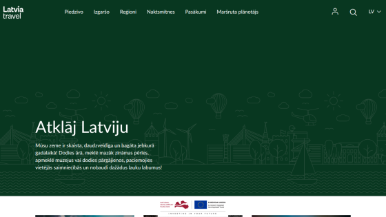 Homepage of Latvia Travel featuring the slogan 'Atklāj Latviju' and a green background.