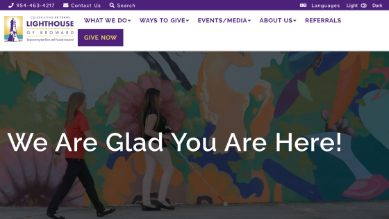 Homepage with navigation bar, large hero image showing a person using a laptop, headline 'Empower Your Business with Our Solutions' and a call-to-action button