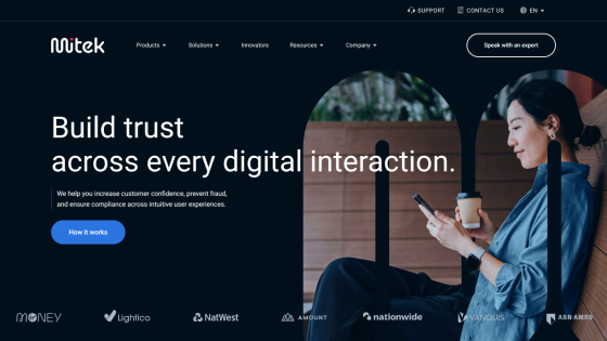 Homepage featuring a woman using a phone with the text 'Build trust across every digital interaction.'