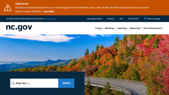 North Carolina government website homepage with scenic mountain road image and search bar