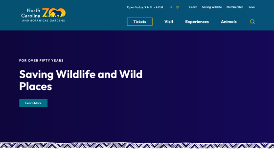 North Carolina Zoo homepage with navigation and headline 'Saving Wildlife and Wild Places' and a Learn More button