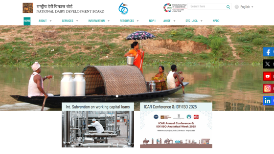 National Dairy Development Board homepage with navigation menu, hero image of people on a boat, and announcements on loans and conference