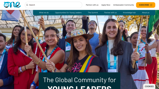 The Global Community for Young Leaders with diverse group of smiling participants holding flags.
