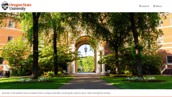 Oregon State University campus entrance with trees and pathway.