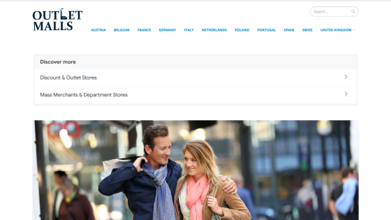 Homepage of Outlet Malls featuring navigation links and a couple in a shopping setting.