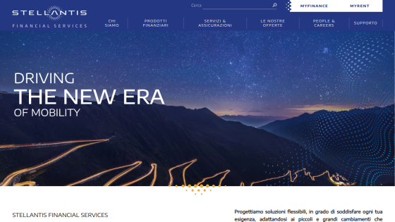 Stellantis Financial Services homepage with navigation and hero text 'Driving the new era of mobility' over a night mountain road background