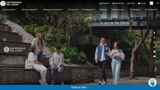 Students walking on campus with greenery and university branding in view.