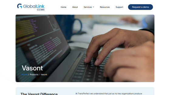 Vasant product page showcasing a hand typing on a laptop with coding on the screen.