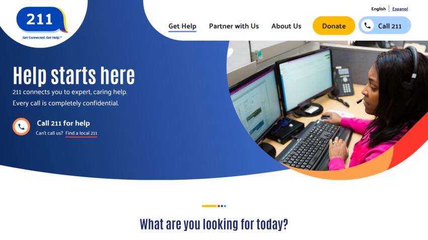 Homepage of 211 service with a call to action for help and a woman at a computer.