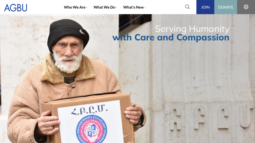 Humanitarian organization homepage with elderly man holding aid box and text 'Serving Humanity with Care and Compassion'