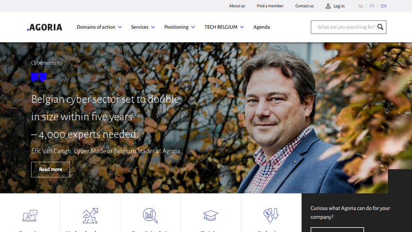 Agoria website hero section about Belgian cyber sector growth with a man in a suit and autumn leaves background
