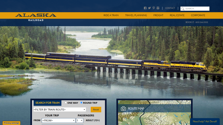 Alaska travel website featuring a scenic mountain view and trip planning options.