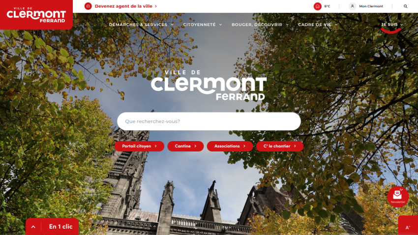 City of Clermont-Ferrand website homepage with navigation menu, search bar, and autumn trees framing cathedral towers