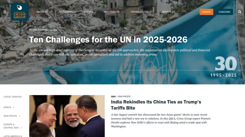 Main headline on UN challenges with a background image of a damaged cityscape.