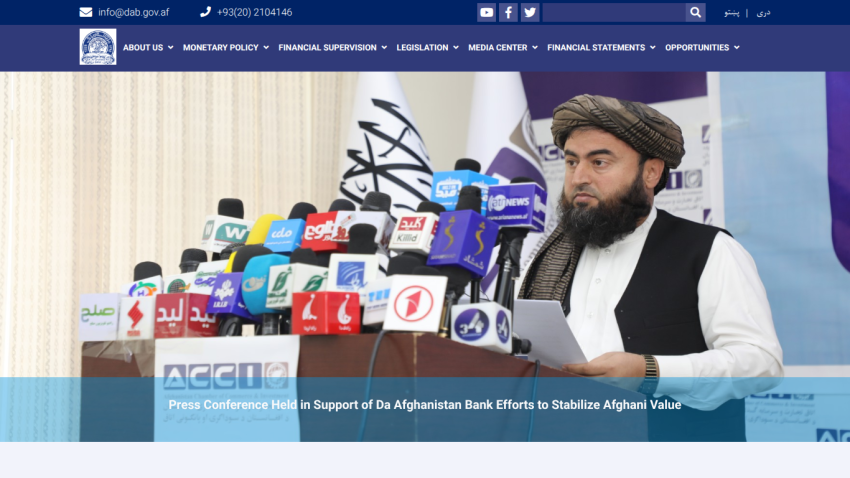 Press conference supporting Da Afghanistan Bank efforts to stabilize Afghani value with multiple microphones and speaker.