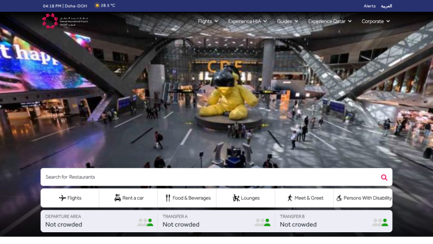 Airport terminal with large yellow bear sculpture, search bar for flights, hotels, and more, and navigation menu