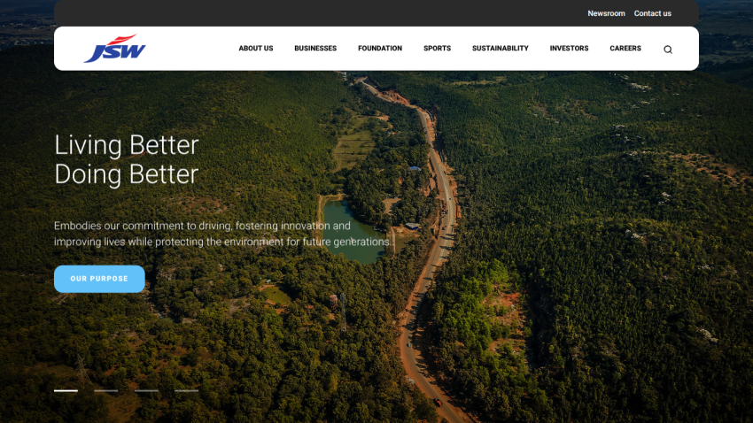 Corporate website homepage with navigation bar and hero section featuring aerial view of forest and road, tagline 'Living Better Doing Better'