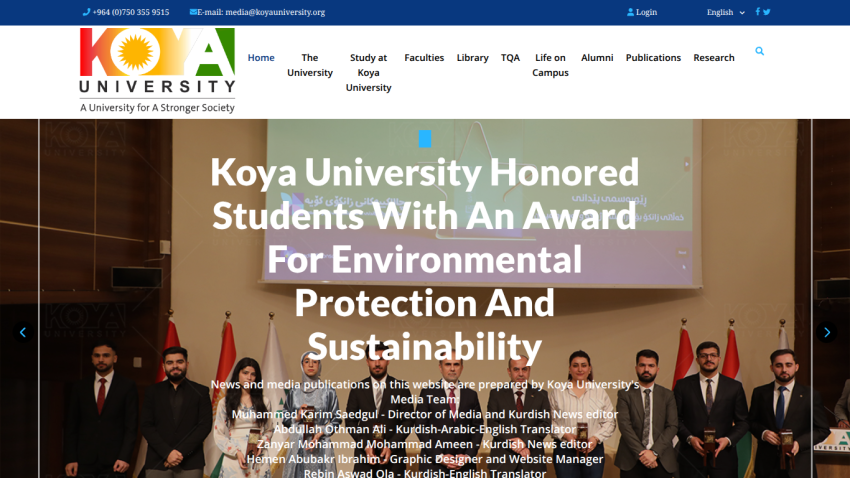 Koya University homepage with navigation menu and a hero image showing a group of people standing in front of flags and a projection screen