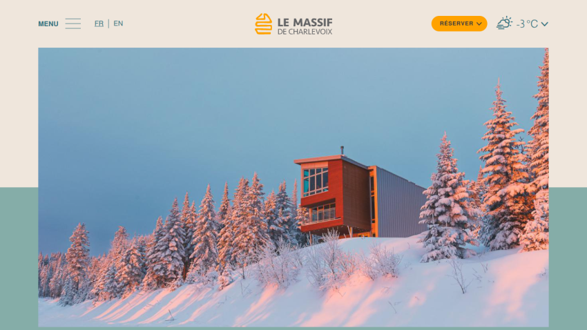 Le Massif de Charlevoix website header with snowy landscape and modern building at sunset, menu and reservation options visible