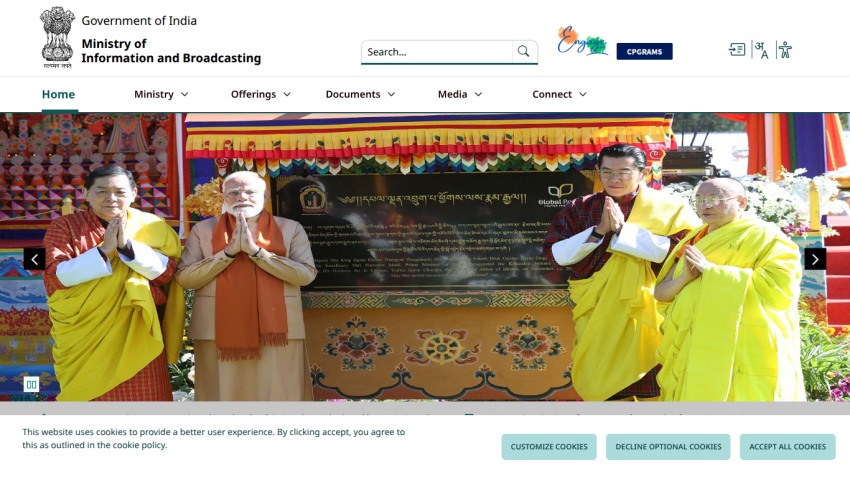 Government of India Ministry of Information and Broadcasting website with navigation menu and hero image of officials in traditional attire
