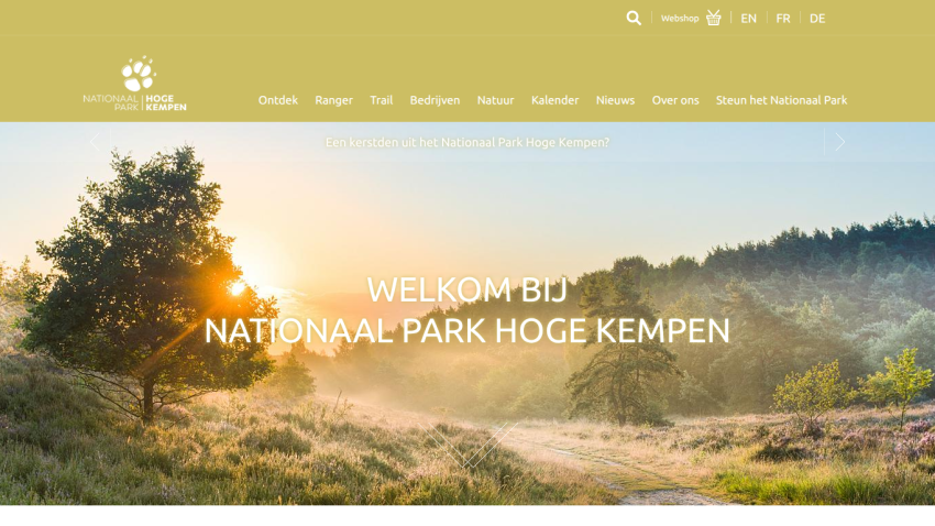 Welcome message and navigation for Nationaal Park Hoge Kempen with a sunrise landscape background