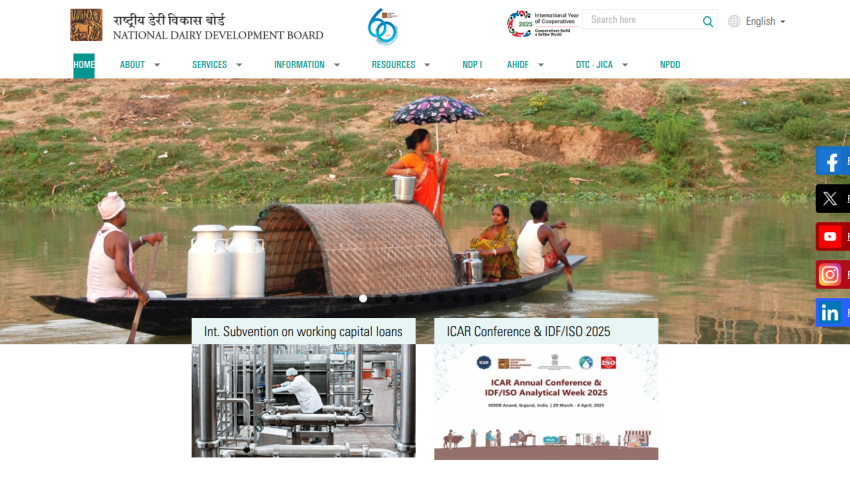 National Dairy Development Board homepage with navigation menu, hero image of people on a boat, and announcements on loans and conference