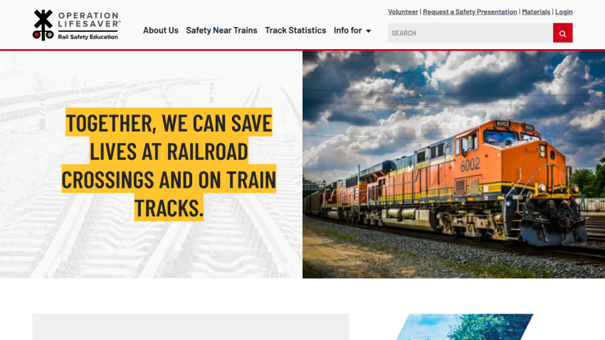 Operation Lifesaver homepage with message about saving lives at railroad crossings and an image of an orange train under a cloudy sky