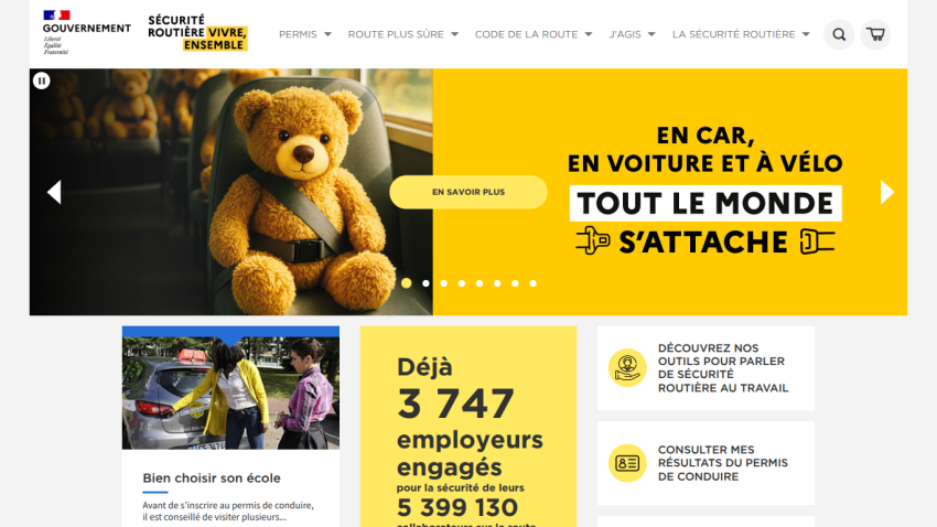Website promoting safety in vehicles with a teddy bear mascot and engagement statistics.