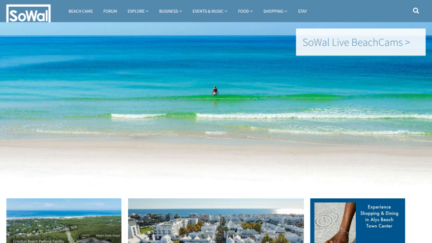 SoWal website with navigation menu and a hero image of a person standing in the ocean waves, promoting live beach cams
