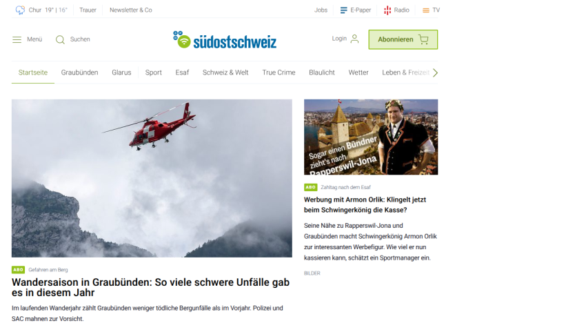 News website featuring a helicopter image and articles about accidents in the mountains.