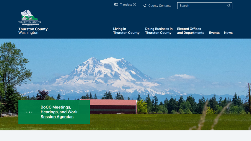 Thurston County Washington official site with navigation links and a scenic mountain landscape background