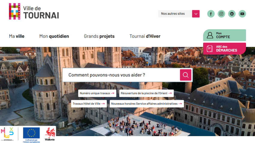 City of Tournai website with navigation menu, search bar, and aerial view of historic buildings