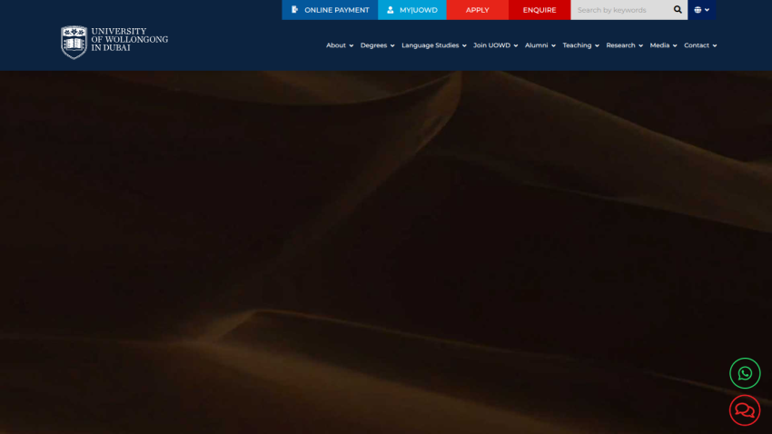 University of Wollongong in Dubai website header with navigation and desert sand dunes hero image