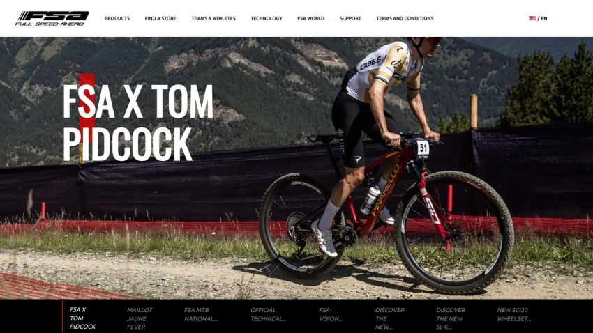 Cyclist Tom Pidcock riding a mountain bike with FSA branding and navigation menu above
