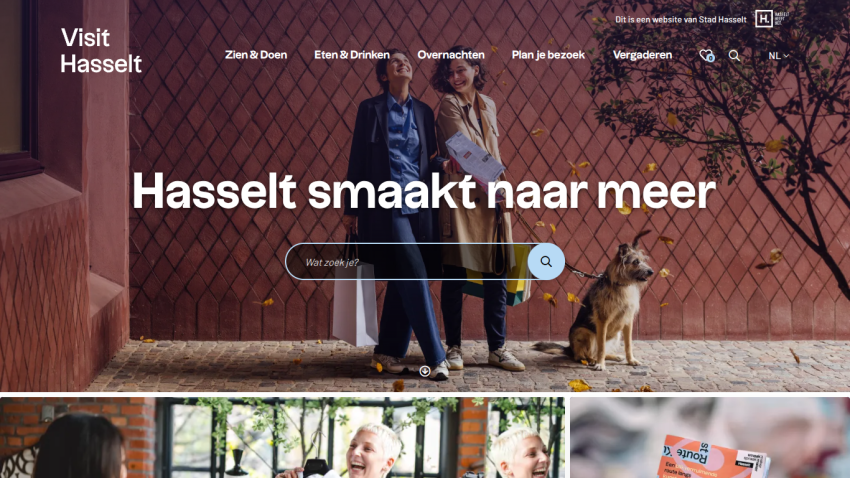Tourism website for Hasselt with navigation menu, search bar, and hero image of two people and a dog