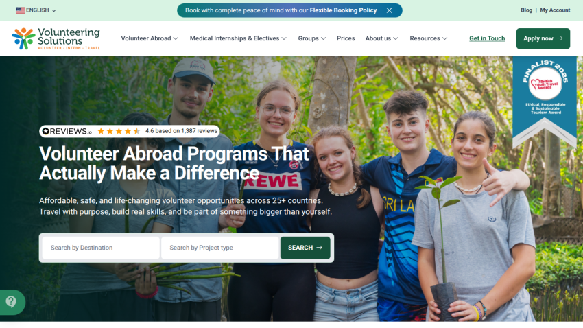 Volunteering Solutions homepage with headline about volunteer abroad programs and a group of smiling young people holding a plant