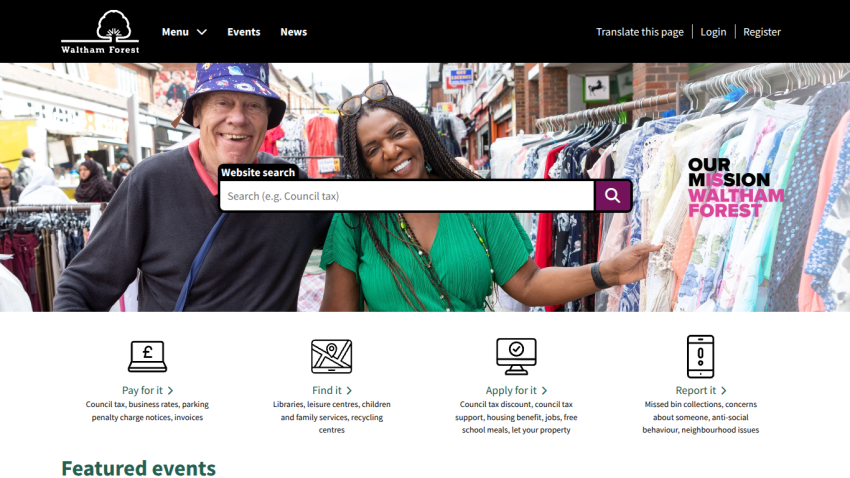 Homepage featuring a search bar and two smiling individuals in a market setting.