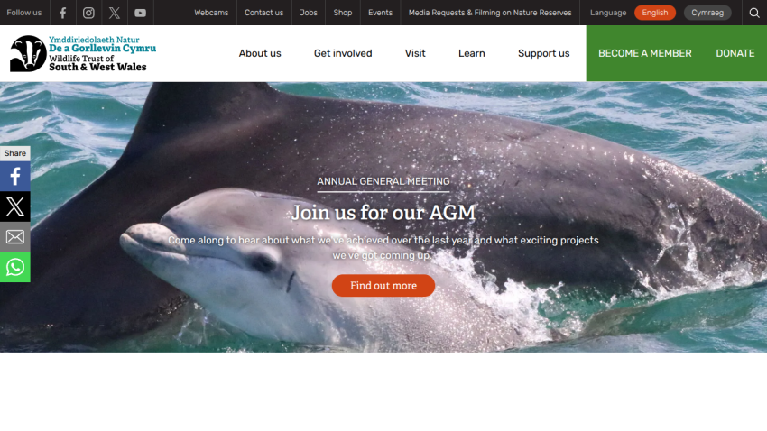 Wildlife Trust of South & West Wales website promoting Annual General Meeting with dolphin image and navigation menu