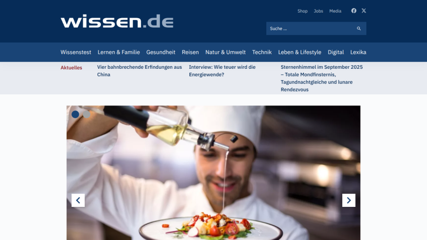 Chef drizzling oil over a gourmet dish in a restaurant setting.