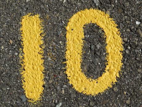 Number 10 drawn with yellow paint on gravel road 