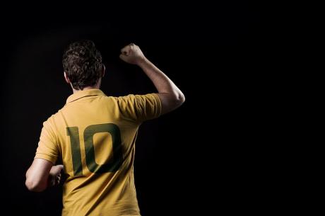 a person wearing Yellow coloured No. 10 jersey photographed from back
