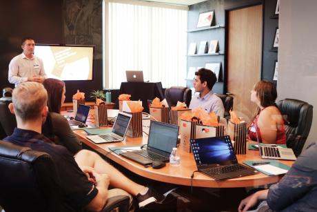 people attending a training session around a conference desk