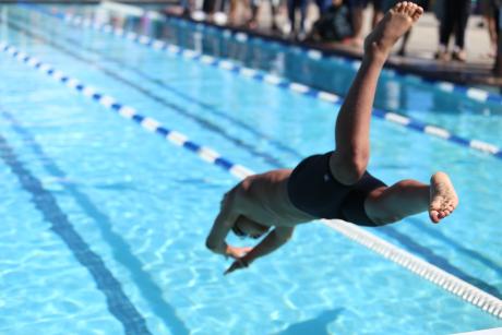 A man diving into a swimming pool