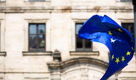 EU flag in the backdrop of a historic building